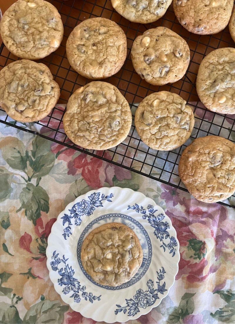 gluten free chocolate chip cookies on wood table and floral tablecloth with flow blue plate