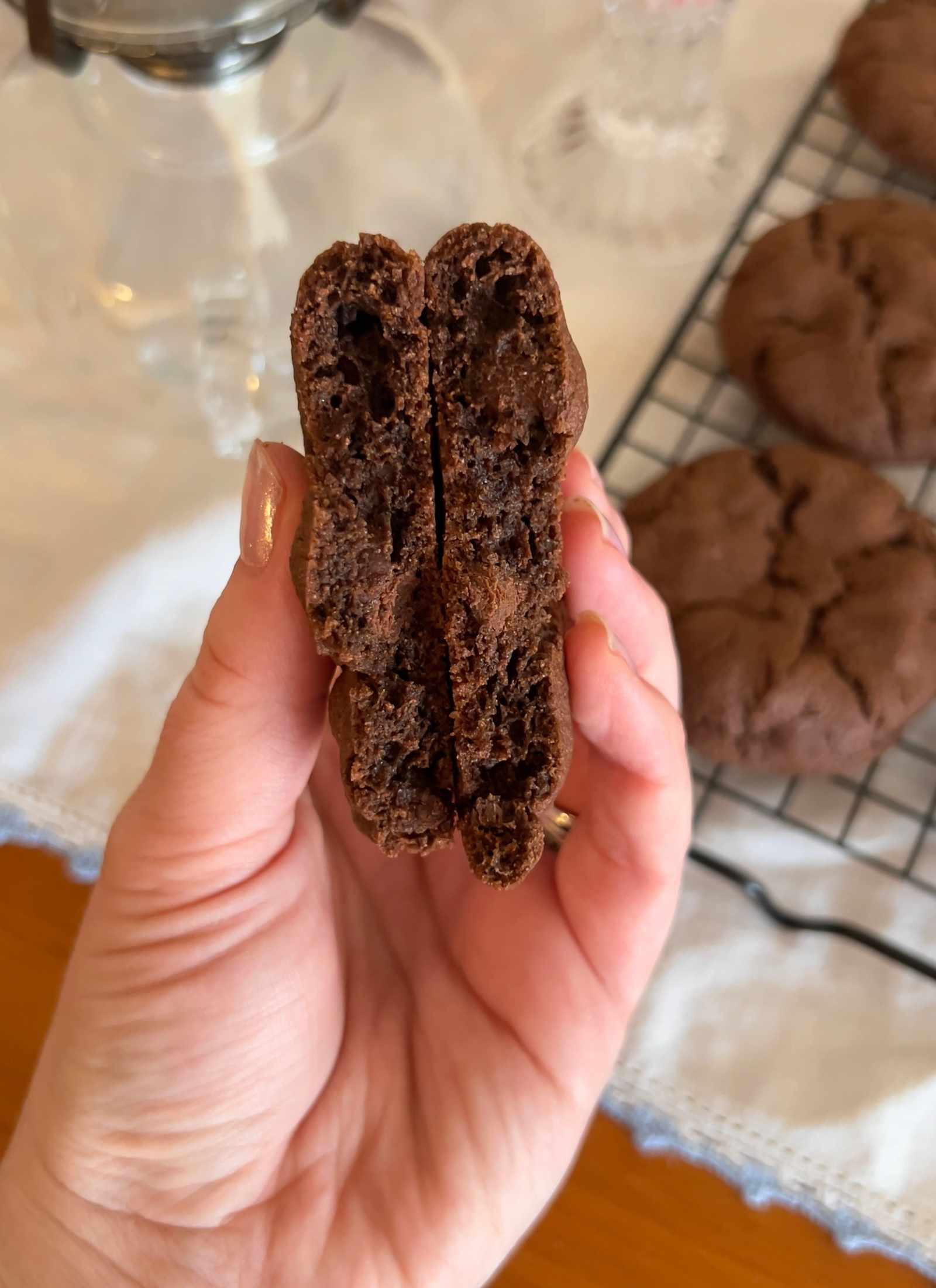 gluten free chocolate chocolate chip cookie two halves held side by side to show inside texture of cookie