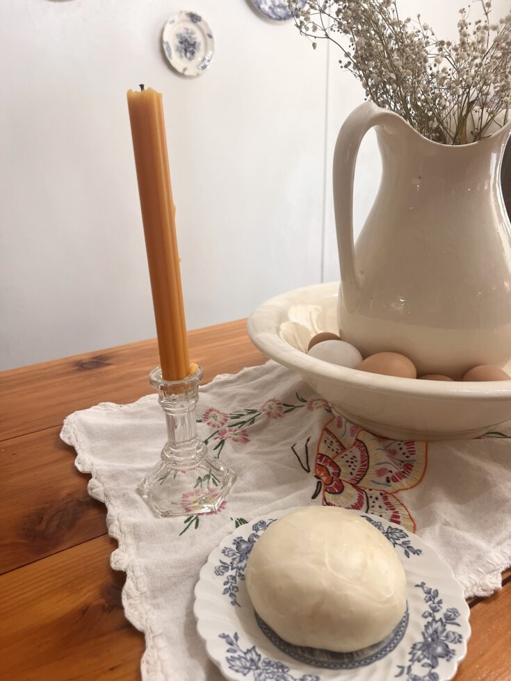 ball of mozzarella cheese sitting on antique ironstone plate