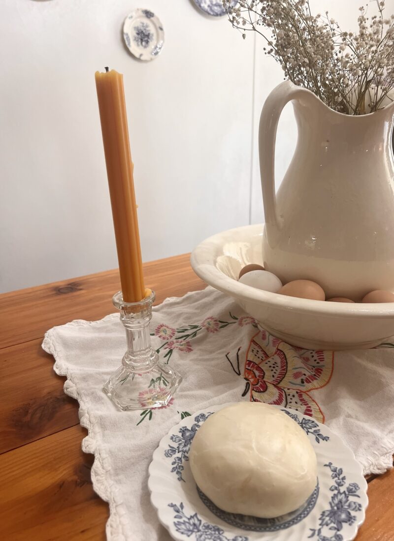 ball of mozzarella cheese sitting on antique ironstone plate