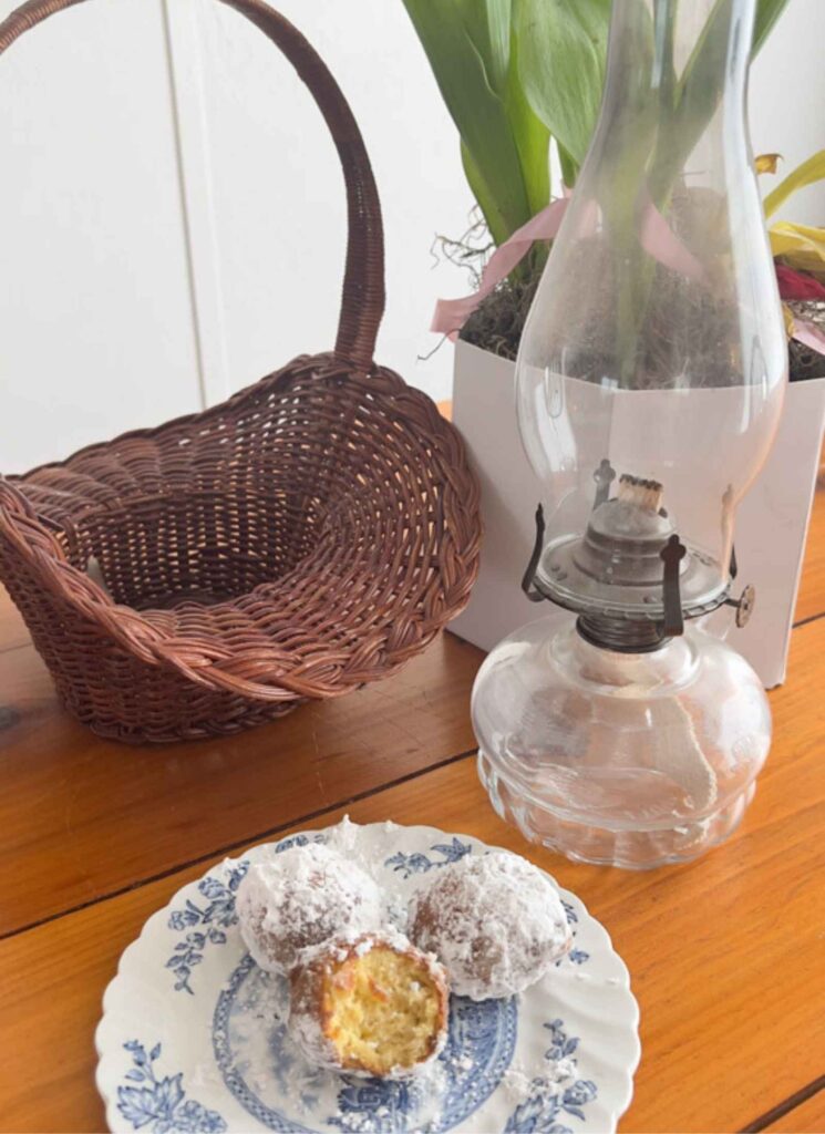 gluten free cake donuts on a blue and white vintage plate with antique oil lamp and basket