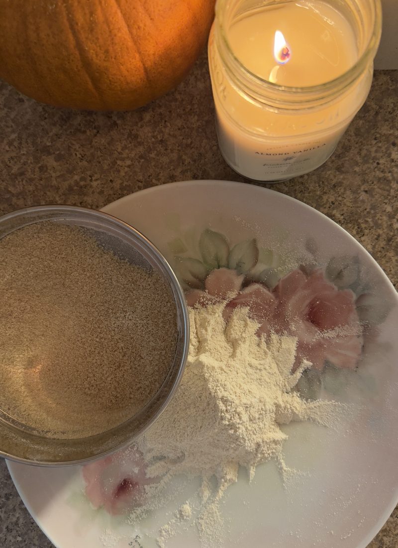 Sifted Bran from fresh milled flour on a vintage rose plate sitting next to a candle in my country kitchen