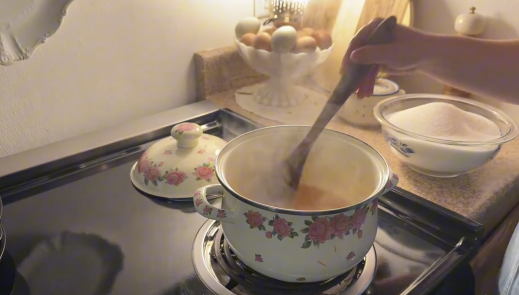 Stirring the pectin into the oranges with an old wooden spoon