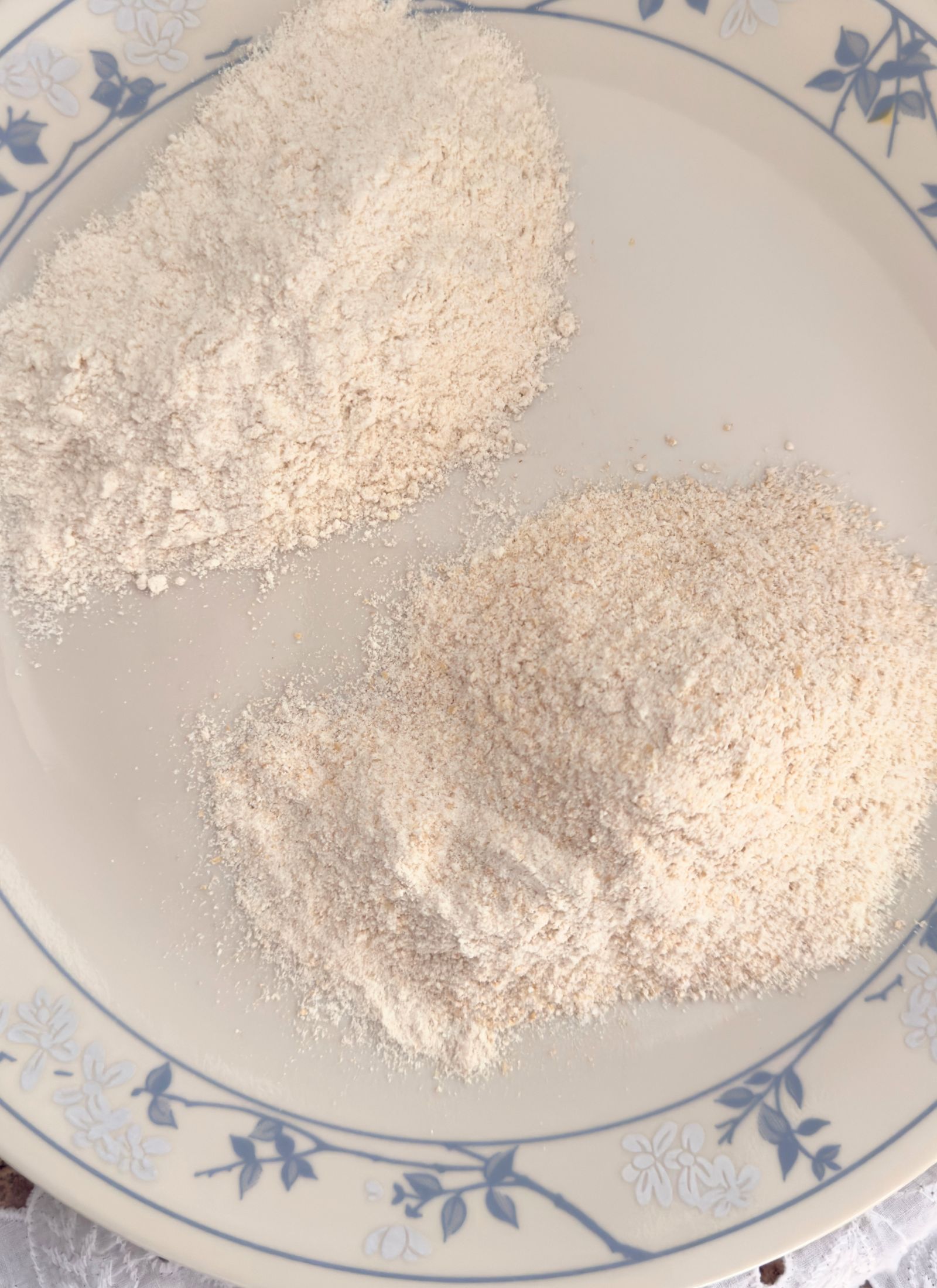 freshly milled all purpose flour blend laid out on a blue and cream correlle plate. Sifted is on the left, unsifted on the right.