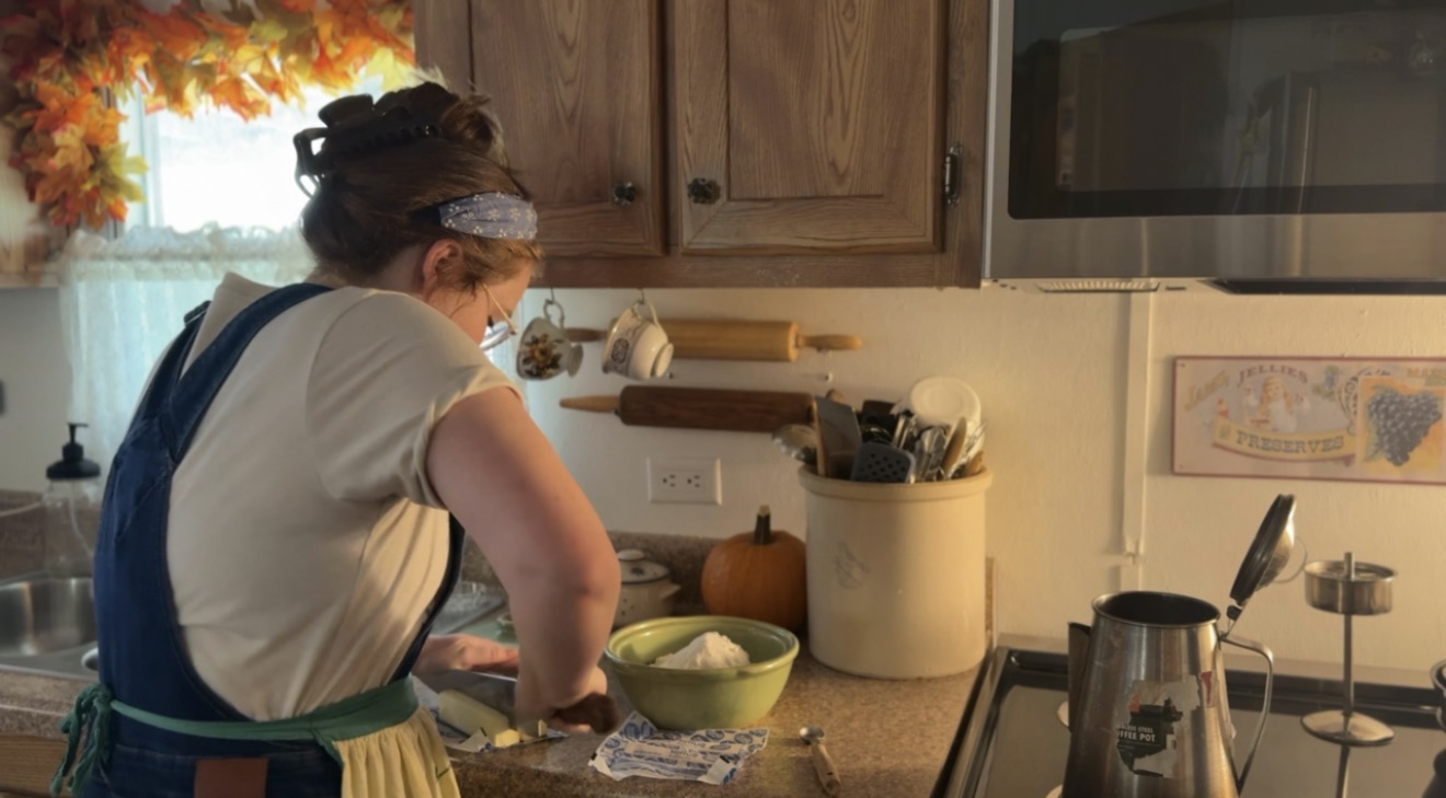 girl in farm kitchen cutting butter